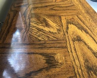 Closeup of the parquet top of the occasional table. Notice the circular notes in the wood. These are not mere "knot fillers." They are an intentional part of the design in all three matching pieces of furniture.