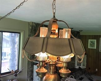Mid-century metal swag lamp with glass chimneys. Has option of four lights illuminating toward the ceiling, one towards the floor, or all five lights together. Excellent shape, great design.