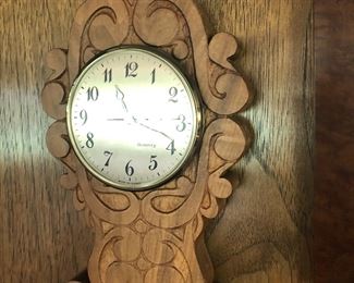 Elegant, small wooden wall clock.