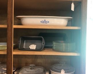More casseroles, teapots, as well as bread pans and clear glass dessert plates.