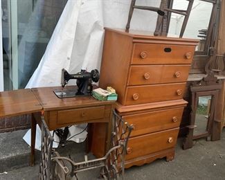 Singer Sewing machine in cabinet and in front a wrought iron treddle machine base just waiting for the top and wa-la you have a great table.