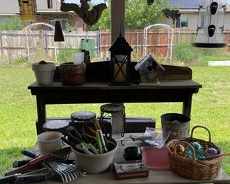 Potting bench with lots of garden tools and decor