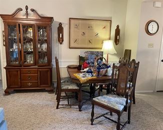 The lighted china cabinet is from the American Independence Collection and inspired by the original furnishings of Independence Hall. Vintage dining table with leaf and six high back chairs