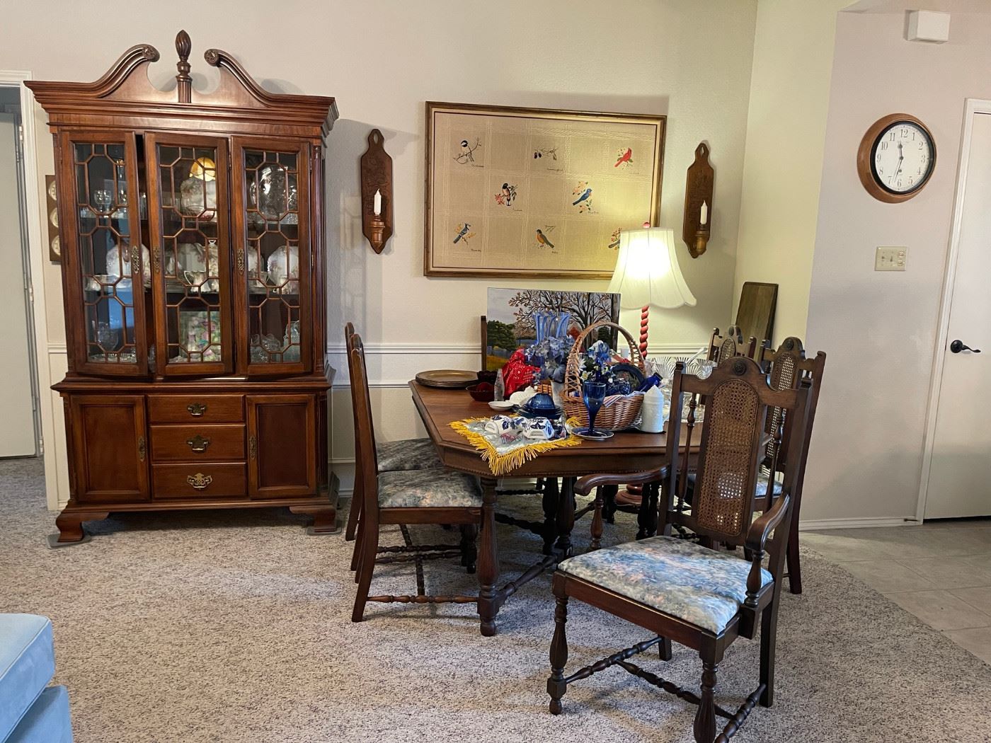 The lighted china cabinet is from the American Independence Collection and inspired by the original furnishings of Independence Hall. Vintage dining table with leaf and six high back chairs