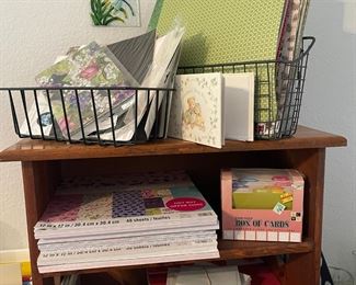 Lots more paper, small wood shelf and wire baskets