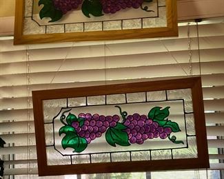 Two purple , green, and clear stained glass pieces 