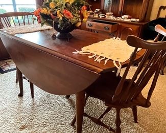 Ethan Allen table. Drop leaf. Has three leaves and five chairs. Solid maple