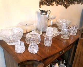 Walnut server and assorted glass wares. Small corner of the ornate Italian mirror in upper right corner.
