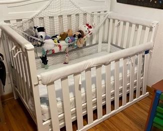 Childrens crib convertible to toddler bed with Kolcraft pure sleep mattress along with net with stuffed animals