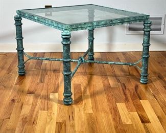 VERDIGRIS LOW TABLE | Green patina frame, having a beveled glass top and an X-form stretcher. - l. 31 x w. 31 x h. 21 in