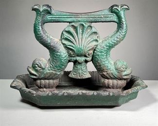 ANTIQUE CAST IRON BOOT SCRAPER | Decorated with dolphins (fish) and a central seashell and with old green paint. -  l. 14 x w. 10 x h. 10 in