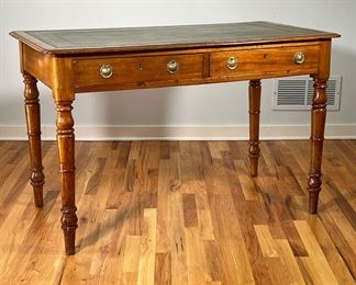 REGENCY STYLE WRITING DESK | Having an inset green leather writing surface with gilt tooled border, over two drawers with double pulls and resting on spindle legs. -  l. 48 x w. 25 x h. 31 in