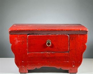 CHINESE LACQUER STOOL | Red lacquered low form stool with shaped front and a single drawer. - l. 22.5 x w. 15 x h. 12.5 in