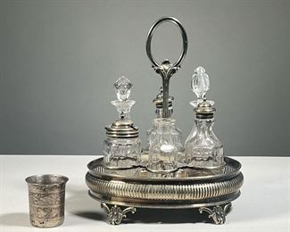 SILVER PLATED CONDIMENT SET | With six glass bottles in a reticulated stand, marked "W&H" on bottom. - w. 9 x h. 10.5 in