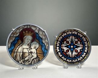 (2PC) STAINED GLASS HANGINGS | Stained glass window hangings with colorful transferred decoration, one of Madonna and Child, the other with a tile design. - dia. 7.25 in (largest)