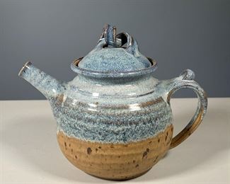 EARTHENWARE BLUE GLAZED TEAPOT | Heavy blue glazed earthenware teapot, twist motif lid, signed by artist on the bottom - w. 10 x h. 8 in