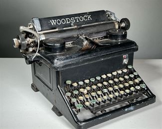 EARLY WOODSTOCK TYPEWRITER | Mechanical typewriter with a black cast iron base, needs cleaning. - l. 17 x w. 14 x h. 10 in