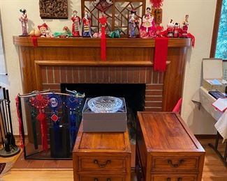 Pair of side tables/nightstands with carved base detail. Piece above the fireplace has same detail and can be sold separately. Also shown, collectible dolls. Side tables sold in a separate photo. (Side tables and wall hanging have sold)