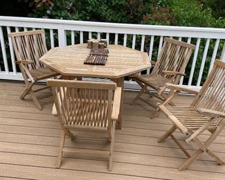 $580 Eight-piece Outdoor teak set. Octagonal table with four armchairs, two side chairs and loveseat. Table measures 47" octagon x 29"h, Arm chairs 35"h x 22"w x 20"d, side chairs 19"w x 20"d x 35"h