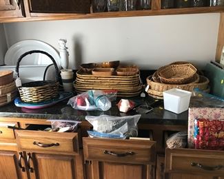 Numerous serving baskets, plates, cutting boards, jars, storage