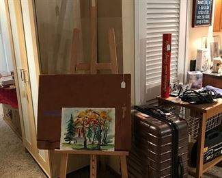 Another nice watercolor.  Notice wood easel and portfolio, Travelpro luggage, Kitchen drop leave table on casters