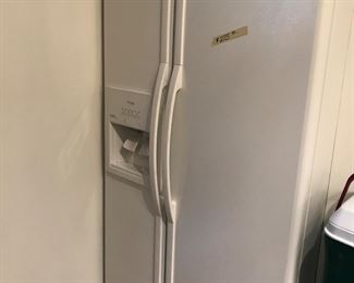 Whirlpool side by side refrigerator with water/ice dispenser.