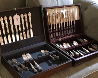 two sets of silver-plate flatware