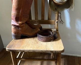 Frye boots, leather belt, woman’s hat, wood chair