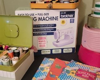 Full-size sewing machine and plenty of thread and fabric to go with it!