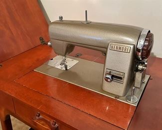 Vintage Kenmore sewing machine in cabinet with matching stool