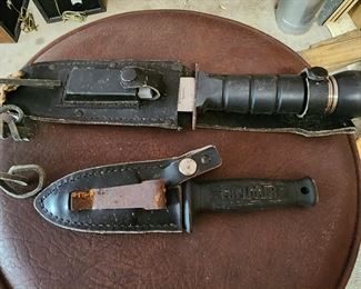 Camp knives on work bench stool.