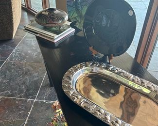 Native American pottery, art glass bowls, aluminum serving tray, and a snippet of yet another silk flower arrangement.