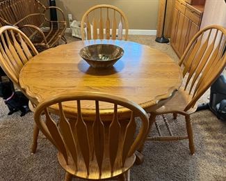 Oak dining table with extra leaf and four chairs