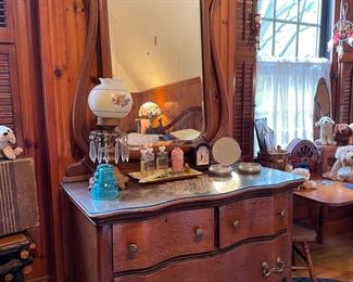 Antique early 1900s wave front Victorian wooden vanity with glass top, framed tilting mirror and caster claw feet in pristine condition