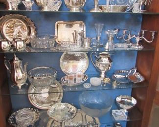 Cabinet filled with Scandinavian serving pieces and tableware: sterling, silverplate and glass