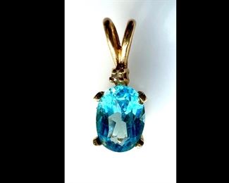 #120 • Small Faceted Oval Blue Topaz and Diamond Chip Pendant in 14K Gold
