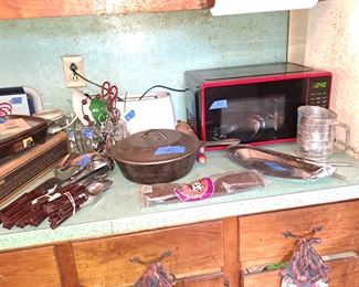 Microwave; vintage plastic handle utensil set; cast iron pot