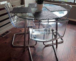 IKEA glass top dining table and 4 acrylic chairs