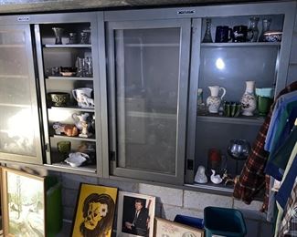 Metal cabinets full of vintage planters, decorative items and glassware