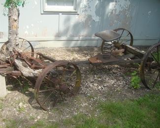 Old wagon w wooden oxen yoke, tractor seat on large metal spring