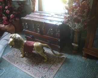 Large brass lion, antique trunk