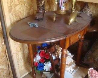 Drop leaf table, brass dolphins