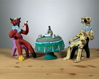 (3PC) JOSEFINA AGUILAR (MEXICAN, 20TH/21ST CENTURY) | Cards with the devil
Handmade clay/art pottery sculpture in three separate pieces, showing Devil and Skeleton playing cards, a table with drinks and cards between them, each piece signed
JOSEFINA AGUILAR (born 1945). - l. 3 x h. 6 in (Skeleton)