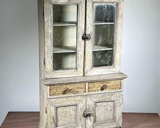 CHILDS STEP BACK CUPBOARD | Child's Step Back Cupboard in old cream paint with swirl decoration. - l. 19.5 x w. 10 x h. 32 in