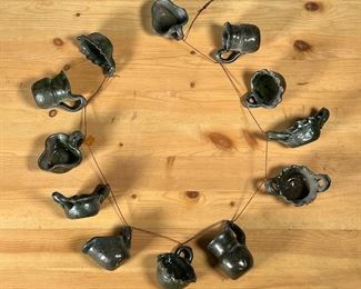 MEG SMEAL POTTERY MINIATURE POTS | Meg Smeal Pottery Display of 12 Miniature Pots. Included is the Grand Award Ribbon from the 1977 Arlington County Fair. - l. 24 in (Lenth of Display)