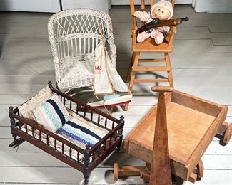 (7PC) VINTAGE TOY LOT | Including Early Doll Cradle (1 leg needs regluing), Doll's Hi-Chair, Wooden Wagon, Wooden Sailboat,
Toy Flintlock, Wicker Doll Chair (Seat Damage) and a Cabbage Patch Baby. - l. 19 x w. 12 x h. 11 in (Cradle)
