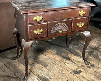 QUEEN ANNE STYLE LOWBOY | Mahogany Queen Anne style lowboy; a low cutlery storage drawer above three small drawers; fan carving; scalloped skirting; four cabriole legs. - l. 19 x w. 34.5 x h. 32 in (overall)