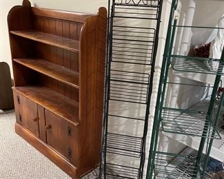 Wooden bookcase with lower cabinet and wire plant stands