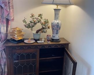Walnut lead-glass front cabinet with 2 shelves; porcelain lamp, jade tree; and cloisonne' dishes and vase