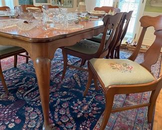 Solid cherry dining table with 8 chairs (6 side and 2 armchairs with needlepoint seat cushions) and shown on top of Persian area rug  -circa 1910 - 100% wool handmade - approx. 8' x 12')  